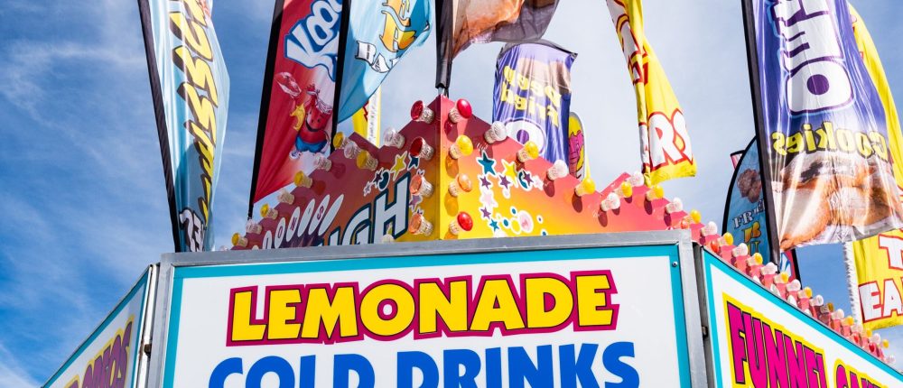 Vibrant carnival stand with lemonade and cold drinks in West Springfield.
